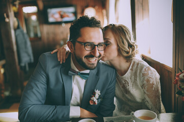 Stylish bridal couple in a cafe, happy bride and groom together