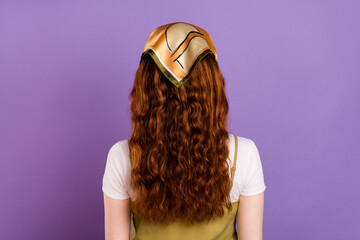 Back rear spine view photo of ginger haired young woman wear headscarf isolated on purple color...