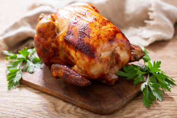 whole roasted chicken on a wooden board