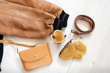 Concept of mushroom leather - jacket, bag and brown tree mushrooms. Sustainable textile made from mushrooms mycelium, vegetable layer alternative to animal leather
