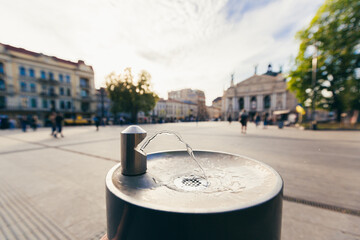 drinking fountain on the background of a large tourist city