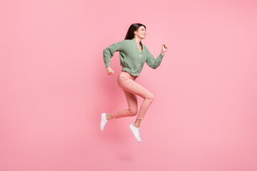 Fototapeta na wymiar Full length profile photo of cheerful attractive lady running jumping isolated on pink color background