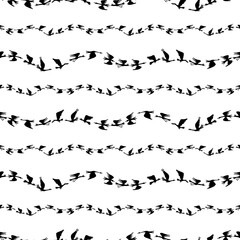 Seamless pattern of silhouettes flocks flying geese in rows