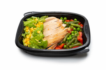 Ready food in a container. Stewed chicken, stewed vegetables.