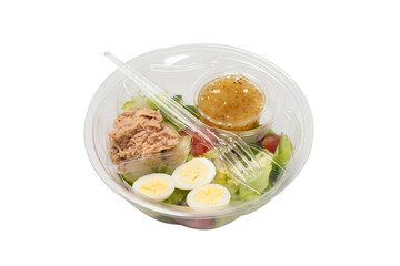 Fresh tuna salad with lettuce, cucombers, cherries and eggs in plastic container.