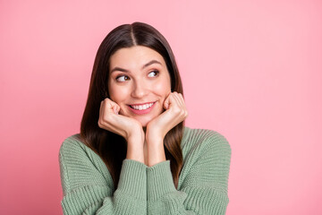 Photo of optimistic cool girl fists head look empty space wear sweater isolated on pink color background