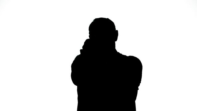 Silhouette of a man on a white background shooting a pistol