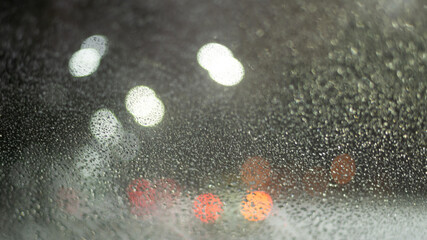 Blurred background with raindrops and lights.
