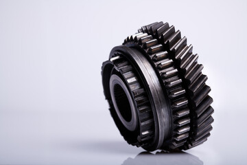 Parts on a gray background. Gears of gear shifting torque transmission. Old gear box parts.