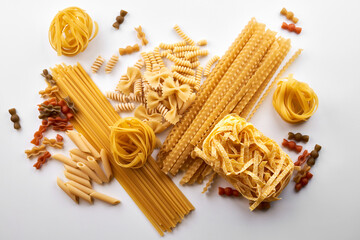 Assorted varieties of pasta wallpaper. Mix macaroni, spaghetti on white background
