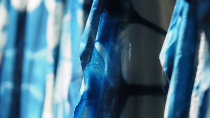 Close up white cloth with blue tie dye in the sunlight. Good absorbency color of fabric , Fibers of...