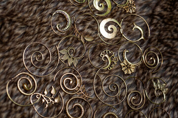 Ornamental brass metal earrings on natural background