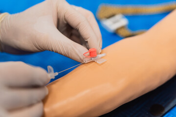 Closeup of nurse's hands taking a blood sample