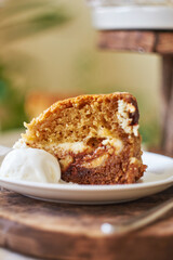 A piece of cake with cream cheese and chocolate. Side view.