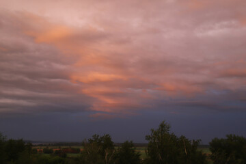 Fototapeta na wymiar gloomy sky with relief colored clouds