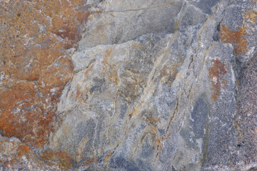 Geology. Granite texture. Close-up of gray granite surface. Stone background.