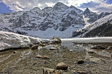view of the Morskie Oko pond in the Polish Tatra Mountains in winter © ambrozinio