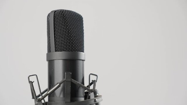 Professional microphone is spinning on a white background. Copy space