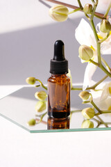 bottle of essential oil with white orchid