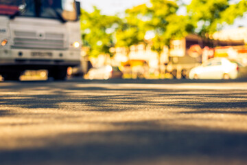 Sunny day in a city, bus rides on the highway, the view from the level of asphalt