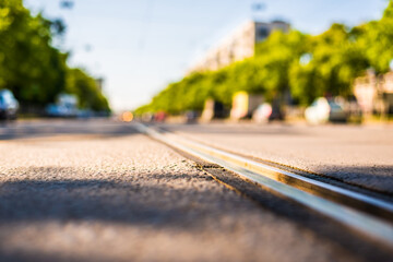 Sunny day in a city, view of the flow of cars approaching from the level of the tram rails