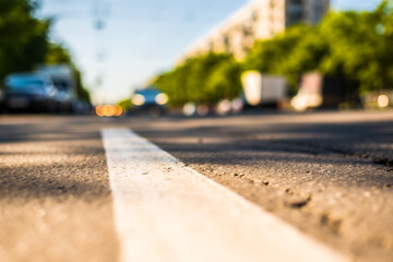 Sunny day in a city, view of the approaching car to the road level