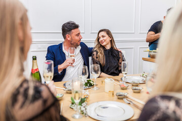 Group of friends enjoying cocktails at an indoor dinner party