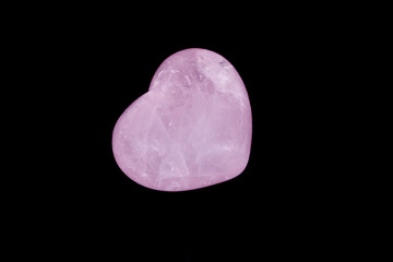 Macro mineral stone Heart pink quartz on a black background