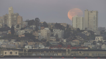 partial eclipse of full blood super moon setting over the outskirts of San Francisco, CA. in early...