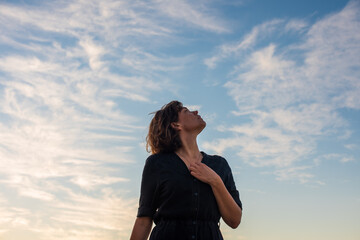 Portrait of woman looking up to the sky - Powered by Adobe