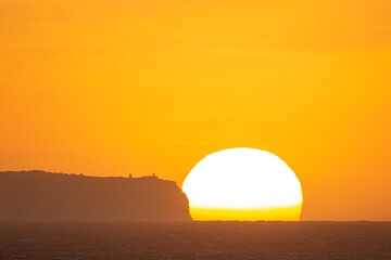 Fototapeta na wymiar sunrise in front of lighthouse