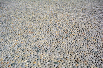 Round cobblestone (pebble) in concrete, street (road) pavement