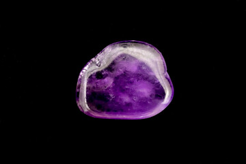 Amethyst jewel stone texture on black background. Macro closeup.