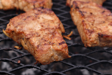 Pork steaks on the grill. Soft focus