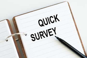 Quick Survey text written on a notepad with black marker
