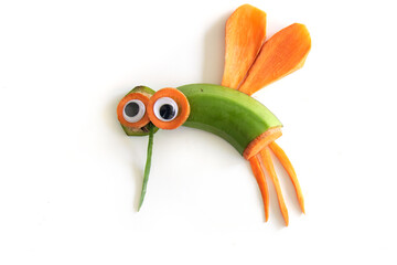 Food art creative concepts. Funny mosquito fly made of fruits and vegetables, such as carrots and cucumber isolated on a white background.