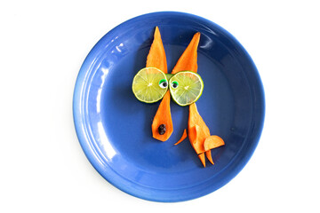 Food art creative concepts. Funny wolf made of fruits and vegetables, such as carrots and cucumber isolated on a white background.