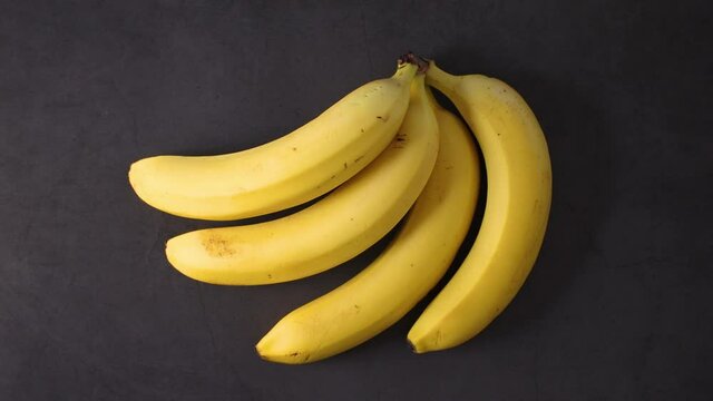 Group of four fresh ripe bananas on the table 
