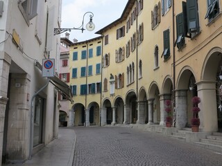 Udine Street View with Traditional Historic Yellow Buildings and Arched Passageway in Friuli, Italy
