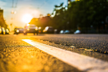 Sunny day in a city, view of the approaching cars to the road level