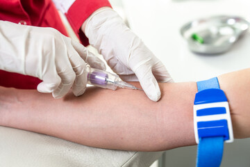 The nurse takes the blood. Blood test