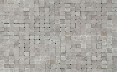 Cobblestone texture. The sidewalk tile is evenly folded. Gray cobblestones close up.
