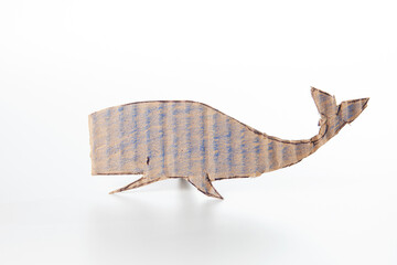 Cute whale made of cardboard on a white background. Children art project. DIY concept. Cardboard craft.