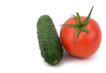 A fresh green cucumber and a red tomato lie side by side, casting a slight shadow