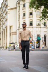 Full length shot of African businessman walking and thinking outdoors in city
