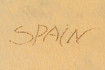 Spain inscription on the sea sand