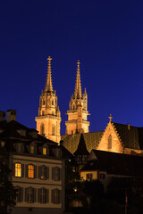 Fototapeta na wymiar The twin tower of the Basel cathedral under the blue night sky