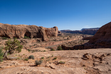 Fototapeta premium Red rock scenery with the Potash Mine train tracks, along the Corona Arch trail in Moab, Utah