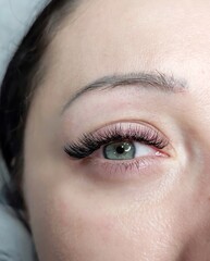 Obraz premium Lash extensions in beauty salon macro eye top view 