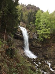Fototapeta na wymiar Waterfall in the Swiss alps mountains